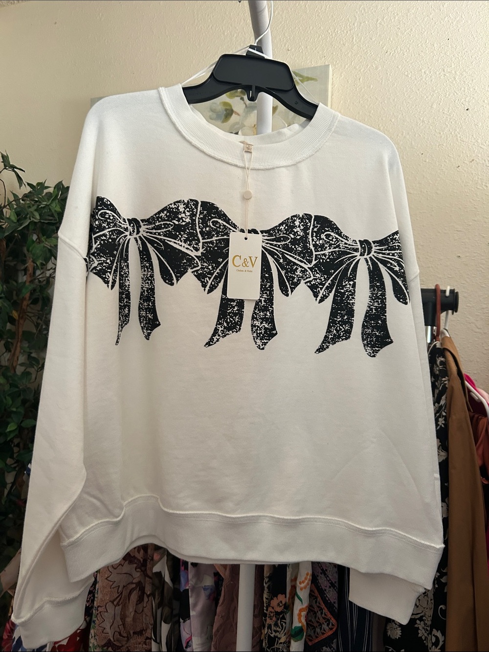 Chelsea & Violet White Crewneck Sweater with Black Bow Print